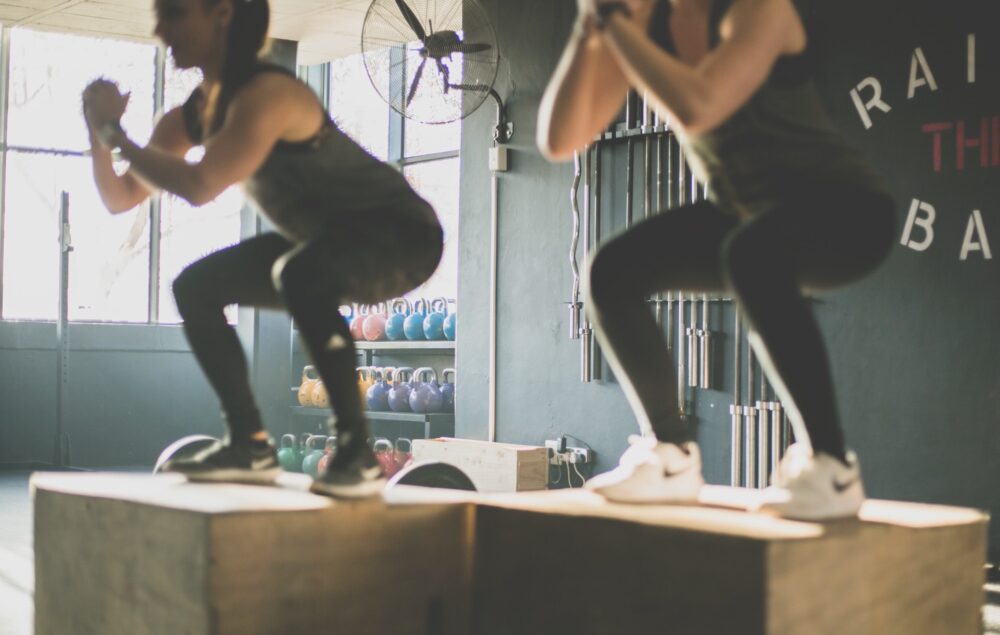 people performing squats an isotonic exercise